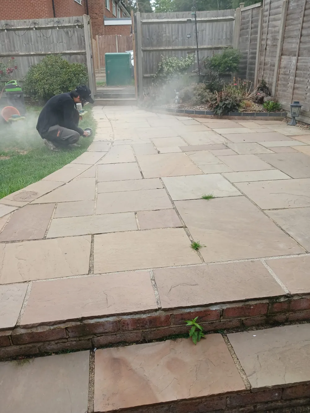 Exterior cleaning specialist pressure washing a residential patio